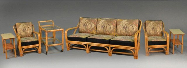 Rattan Suite of Furniture: Comprising a three seat sofa, two armchairs, two side tables and a two tier tea cart. Sofa height 31 inches, length 6 feet 2 inches, depth 32 inches.