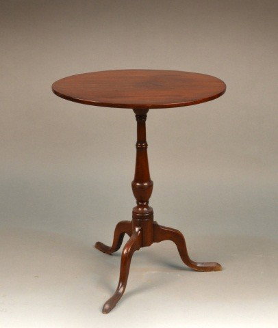 Georgian Mahogany Tilt Top Table: Late 19th century, oval top on turned urn form standard, tripod base. Height 27 inches, width 22 1/4 inches, depth 16 3/4 inches.
