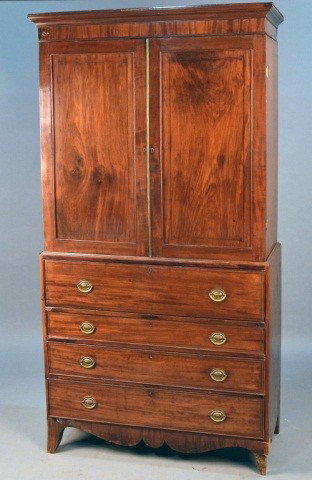 George III English Linen Press: Late 18th/ Early 19th Century with a butler secretary. Raised on French bracket feet. Height 89 inches, width 46 inches, depth19 inches.