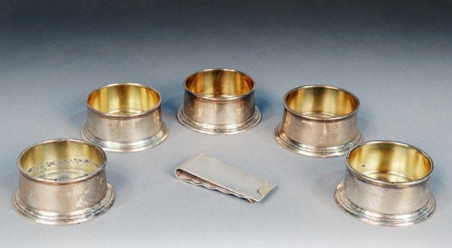 Tiffany & Co. Sterling Silver Articles: Comprising a money clip and five cylindrical salt cellars. Total approximately 8 ounces.