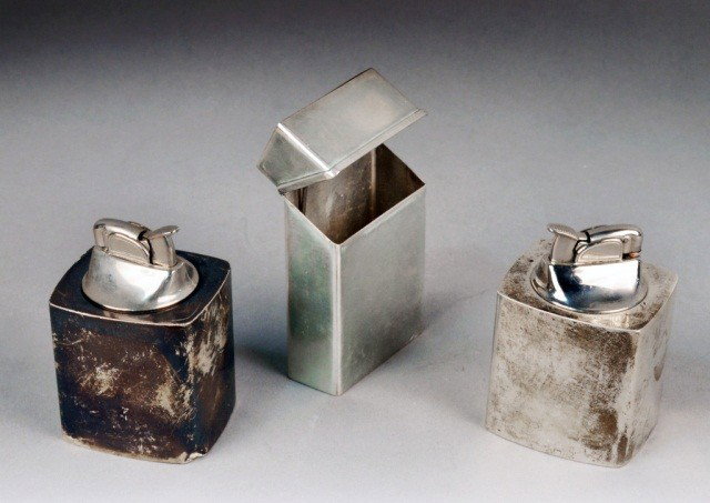 Group of Sterling Silver Smoker's Articles: By Black Starr & Gorham comprising two sterling silver table lighters and a cigarette package cover. Approximately 2 ounces, weighable.