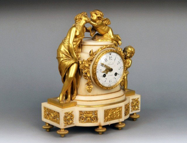 French Gilt Bronze and Marble Mantle Clock: 19th Century, allegorical scene depicting Venus and Cupid. Dial signed Furet, Paris. Height 13 inches, width 10 3/4 inches.