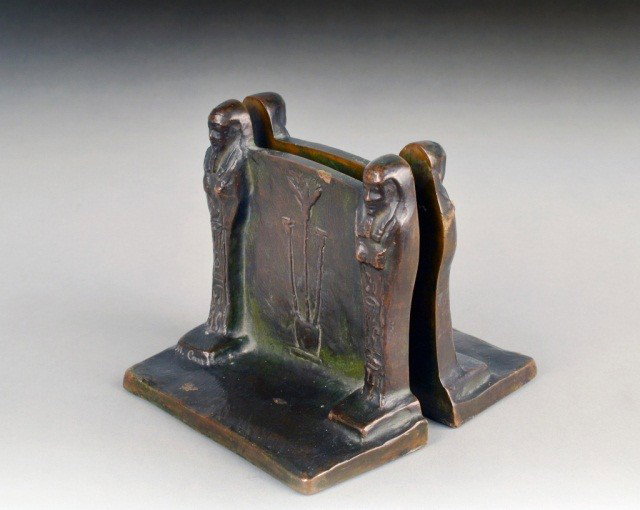Pair of American Patinated Bronze Bookends: Early 20th century, Egyptian revival style inscribed by the artist M. Carr. Height 5 inches, width 6 inches, depth 2 1/2 inches.