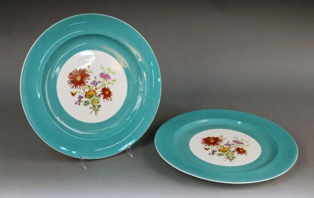 Pair of Minton Porcelain Chargers: Polychome floral decoration within a green border. Hand painted and signed J. Colclough (d. 1953). Diameter 14 inches. Ref: Paul Atterbury and Maureen Batkin, The Dictionary of Minton, p. 260.