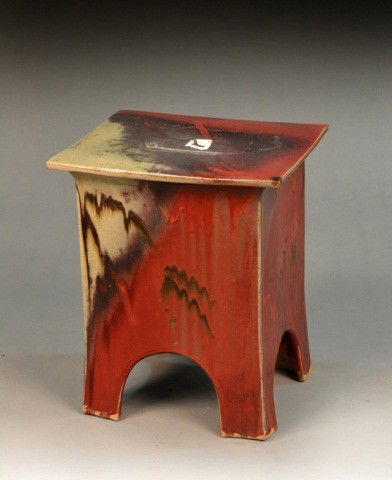Glazed Ceramic Side Table: Rectangular top on four panelled sides with arched bottoms. Height 18 1/2 inches, width 15 1/2 inches, depth 13 1/2 inches.
