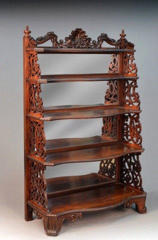 American Rococo Revival Rosewood Etagere: Late 19th century, by Alexander Roux, New York City, the shell and scroll carved crest above five serpentine front shelves flanked by pierced scroll supports, mirrored back. Height 64 inches, width 42