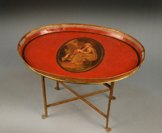 Regency Style Tray Table: Parcel gilt and red painted oval table on a painted metal stand. Height 21 inches, width 28 1/2 inches, depth 22 1/2 inches.
