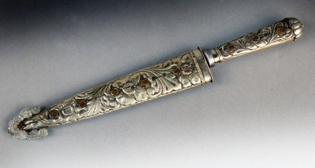 Argentinian Silver Gaucho Knife: Stylized floral and foliate design on handle, with matching scabbard. Stamped Atahualna / Tandil / Argentina. Overall length with scabbard 13 3/4 inches.