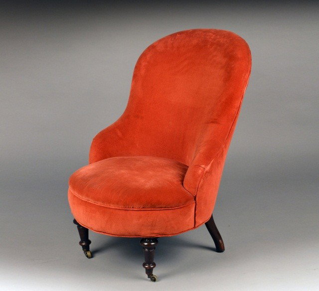 Upholstered Slipper Chair: Rust colored upholstered armless slipper chair. Height 34 inches, width 24 inches, depth 31 inches.