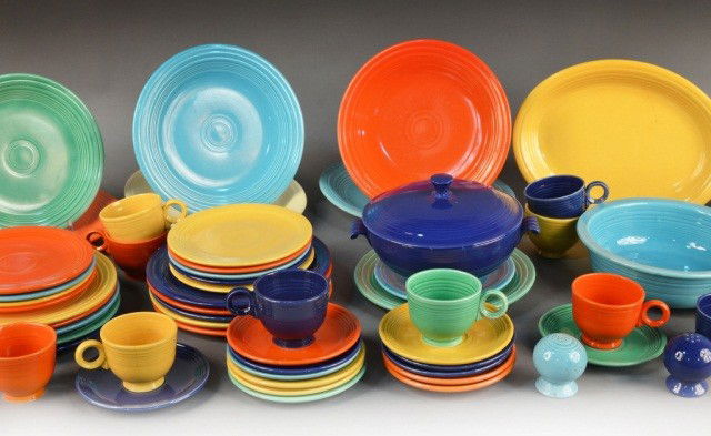 Collection of Original Fiesta Ware: Comprising a circular covered serving dish, circular bowl, four oval platters, two large circular plates, twelve dinner plates, nineteen salad/bread plates, thirteen cups, thirteen saucers, and two sh