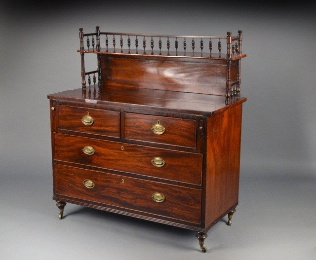English Bachelor's Chest: Early 19th centuy, with slides and a fold over top with inset leather writing surface. Height 48 inches, width 44 inches, depth 21 inches.