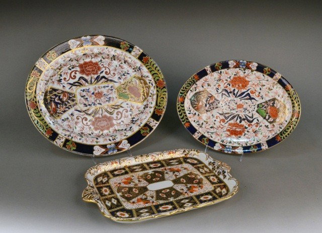 Three Ironstone Platters: Comprising a set of two graduated oval platters and a rectangular platter, all in the Imari palette. Largest length 19 inches.