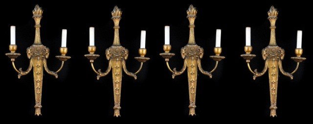 Set of Four Neoclassical Style Two Arm Sconces: Gilt wood carved with ram's head and torch motif. Height 22 inches, width 12 inches.