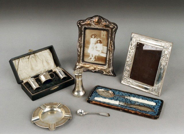 Miscellaneous Group of Silver Articles: Comprising two sterling silver picture frames, ashtray, salt spoon, caster, boxed condiment set and two silver plated serving pieces with bone handles. Total approximately 7 ounces, weighable.