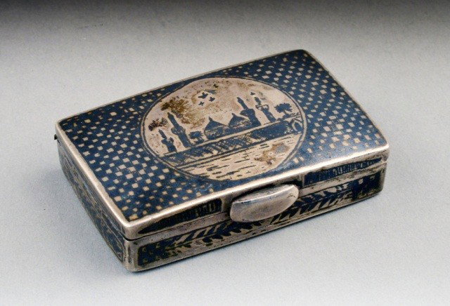 Russian Silver and Niello Snuff Box: Rectangular with geometric decoration centering a Russian city scene. 2 1/2 x 1 1/2 inches. Approximately 2.5 ounces.