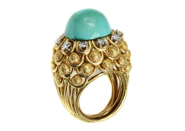 David Webb Gold Diamond and Turquoise Ring: 18k yellow gold ring with Interchangeable center stone, now mounted with a turquoise cabochon and surrounded by ten round diamonds, signed David Webb. 12.9 dwts.