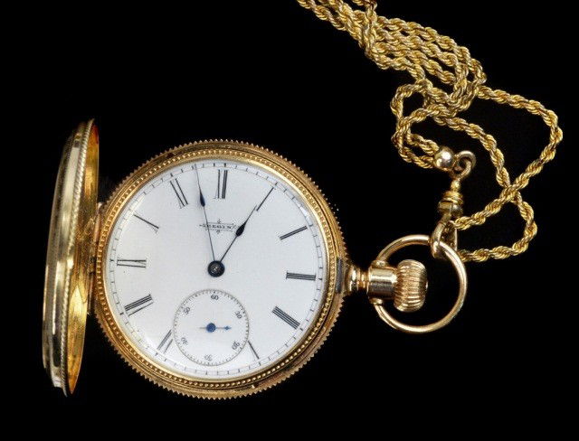 Gold Pocket Watch and Gold Filled Chain: Elgin 14k yellow gold hunt case watch; together with a gold filled watch chain.