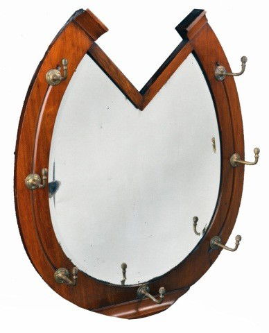 English Mahogany Mirror: Late 19th century, in the form of a horse shoe, surmounted with brass coat hooks. Height 30 inches, width 25 1/2 inches.