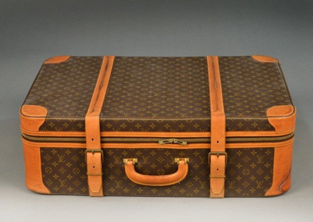 Two Louis Vuitton Suitcases *: Each a soft sided cases with leather strap and trim, and with original keys and luggage tags . Height 10 inches, width 32 inches, depth 21 inches.