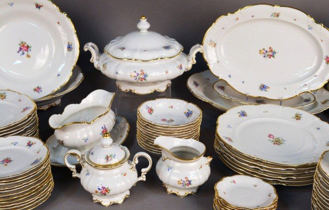 Hutchenreuter Porcelain Dinner Service: Twelve dinner plates, twelve salad plates, twelve bread plates, twelve fruit bowls, eleven cups and twelve saucers, three graduated platters, two cake plates, covered entree dish, sauce boat, cream an