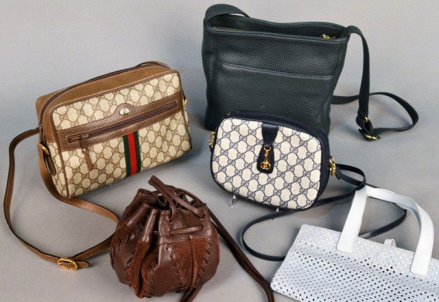 Group of Twelve Lady's Designer Handbags: Including two Gucci bags, two Coach bags, Givenchy evening bag, Fendi bag, Saks brown leather sack, Cole Haan, two Furla bags, straw bag, etc. Coach bag, height 9 1/2 inches.