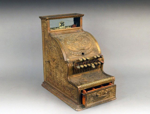Vintage Cash Register: Early 20th century National Cash Register model 311, serial number 660443 featuring a dolphin pattern brass case and missing marquee. Height 17 inches, width 10 inches, depth 15 inches.(As Is Conditio