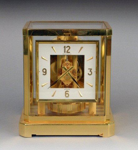 Jaeger LeCoultre Atmos Clock: Model 528-8, with brass and glass case, square face and exposed movement, serial number 422805, height 9 1/4 inches, width 8 1/4 inches, depth 6 1/2 inches.
