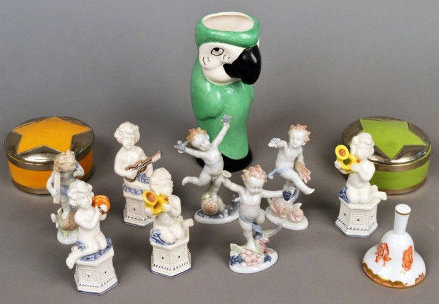 Miscellaneous Group of Ceramic Decorations: Comprising a parrot vase, a pair of Moroccan pottery covered boxes, set of German porcelain figures of the four seasons, set of four Italian porcelain putti musicians, Herend porcelain bell. Vase, hei