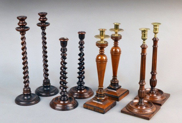 Four Pairs of Wood Turned Candlesticks: Comprising two pairs of barley twist candlesticks, a pair of fluted columnar candlesticks with brass candle cups and a pair of turned wood candlesticks with brass drip pans and candlecups. Tallest pai