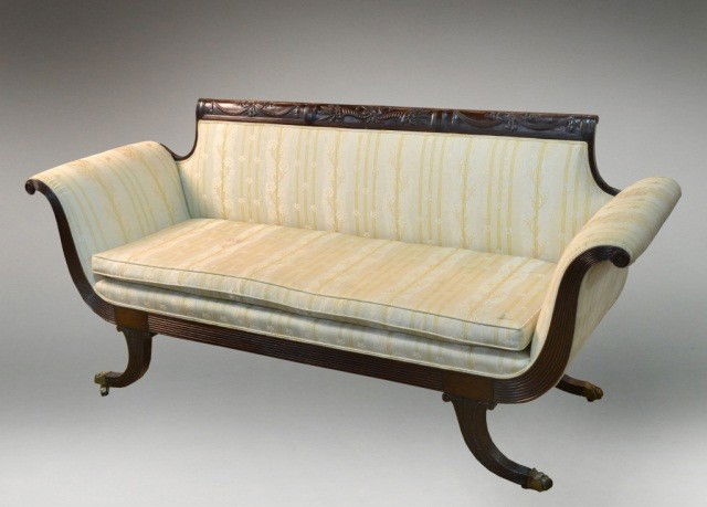 American Mahogany Settee *: Early 19th century Duncan Phyfe New York, with tablet form crest rail carved with cornucopia and ribbon garlands, rectangular back flanked by outscrolled arms, cushion seat, splayed reeded legs ending