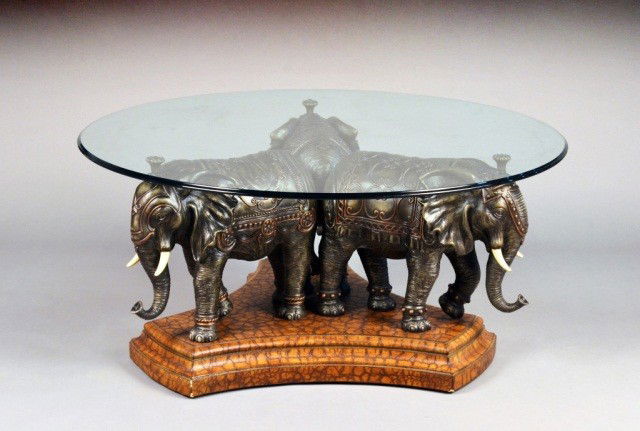 Glass Top Coffee Table: Circular with three elephant base. Height 20 1/4 inches, diameter 44 1/2 inches.