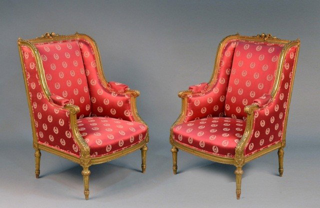 Pair of Louis XVI Style Gilt Bergeres *: Upholstered in red fabric with napoleonic bee in gold. Height 41 inches, width 28 inches, detph 30 inches.