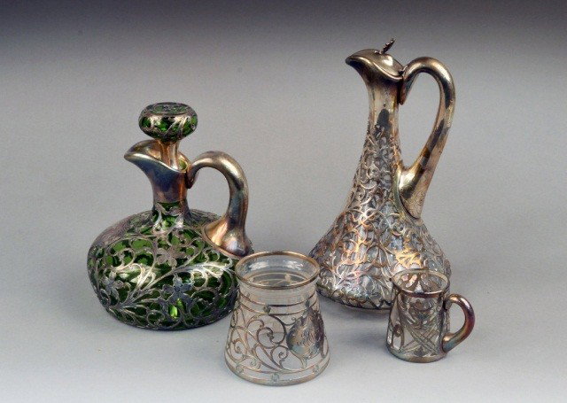 Group of Silver Overlay Glass Articles: Comprising a Gorham silver on colorless glass ewer, height 10 1/4 inches, an Alvin silver on green glass ewer, height 8 inches, a silver overlay jar, height 3 3/4 inches and a Black Starr and Frost si