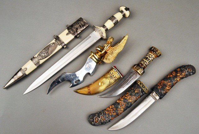 Miscellaneous Group of Edged Weapons: Comprising a Japanese style tanto, a Pakistani dagger with a winged female figural hilt, a Vietnam veteran commemorative short sword, and a North African dagger. Longest blade length 12 7/8 inches.