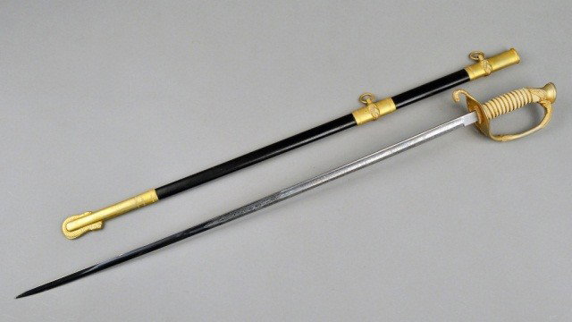U.S. Navy Ceremonial Sword: 20th Century, German steel blade with etched decoration, shagreen handle and leather scabbard with brass mounts. Blade length 29 1/2 inches.