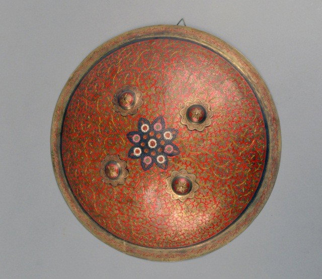 Middle Eastern Circular Shield: Knopped with allover polychrome floral decoration. Diameter 17 5/8 inches.