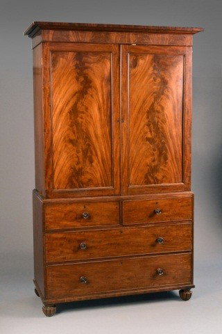 George III Mahogany Linen Press: Pediment top above two paneled doors over two short and two long drawers, bracket feet. Height 86 inches, width 52 inches, depth 23 1/2 inches.