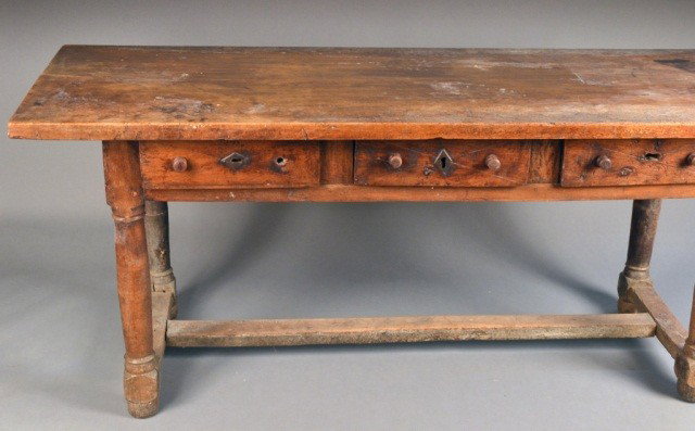 Continental Three Drawer Trestle Table: Late 17th century, with over hanging top and cross stretcher. Height 32 inches, width 75 inches, depth 27 inches.