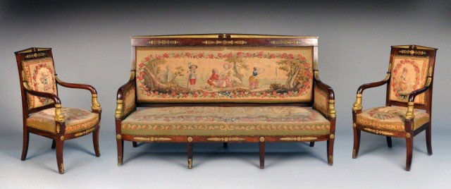 Suite of French Empire Seating Furniture: 19th century, suite comprised of a settee and two fauteuils, each with parcel gilt mahogany with gilt dolphin motif, upholstered with 18th C. tapestry from Brussels, Belgium. Settee, height 42 inches,