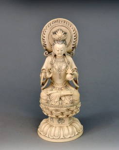 Chinese Carved Ivory Figure of Female: Late 19th century, carved seated in lotus position and holding an orb. Height 12 inches.