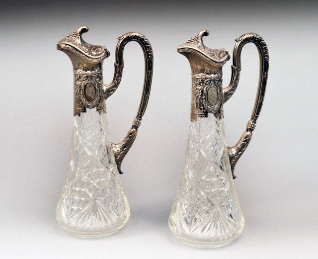 Pair of Russian Silver Mounted Ewers: Each with diamond and fan cutting and acanthus, ribbon and laurel wreath decoration. Height 12 inches.