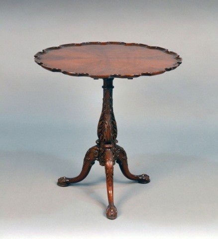 George III Style Mahogany Tilt Top Table: Pie crust top on acanthus leaf carved pedestal with scroll legs and ball in claw feet. Height 28 inches, diameter 28 inches.