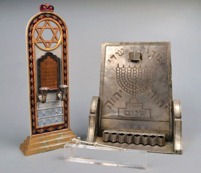Three Judaica Articles: Comprising a silvered torah pointer on a lucite base, an oil burning menorah, and a memorial candle holder.