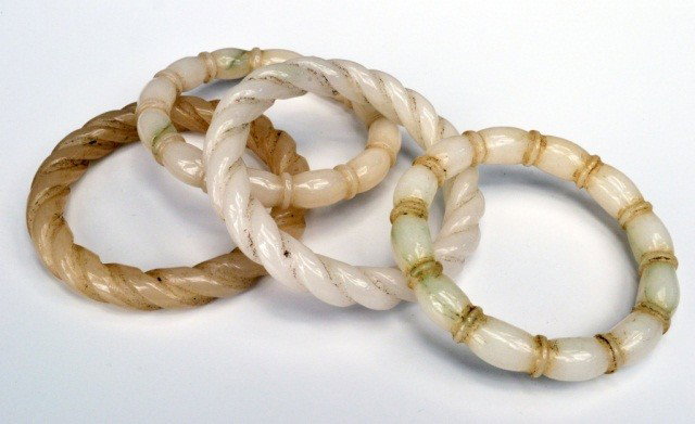 Two Pairs of Carved Jade Bangles: One pair carved as twisted ropes and the other as tied ropes.