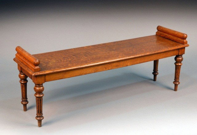 English Oak Hall Bench: Late 19th century, with a plank seat raised on four reeded legs. Height 20 inches, width 53 1/2 inches, depth 15 inches.