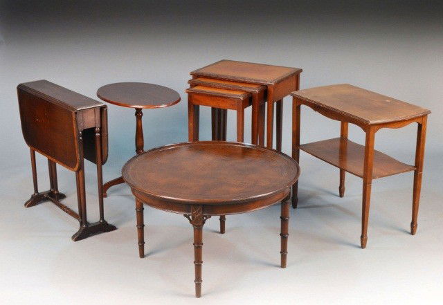 Five Small Tables: Comprising a nest of three tables, a two tier side table, a drop leaf sutherland style table, a circular low table and a tripod table. Circular low table, height 17 inches, diameter 28 inches.