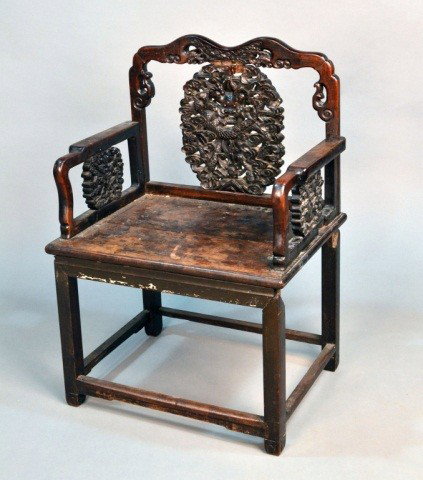 Asian Teak Chair: Shaped rectangular back with carved scroll decoration and carved dragon splat with similar arms and seat, above four rectangular legs ending in scroll feet, joined by a box stretcher. Height 39 1/2 in