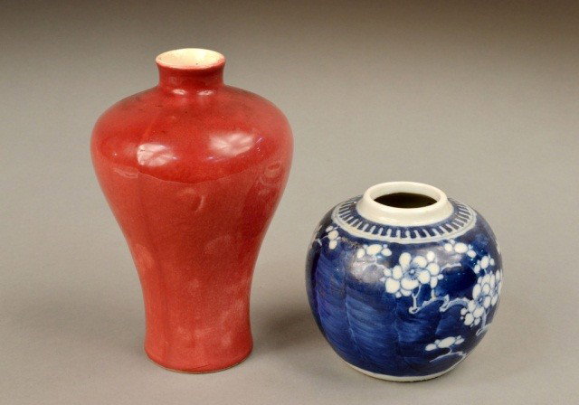 Two Asian Porcelain Vases: One, a sang de beouf glazed, of inverted baluster shape, height 7 inches; and the other, a blue and white floral decorated globular vase, height 4 inches. Ex. Coll. Martha Graham