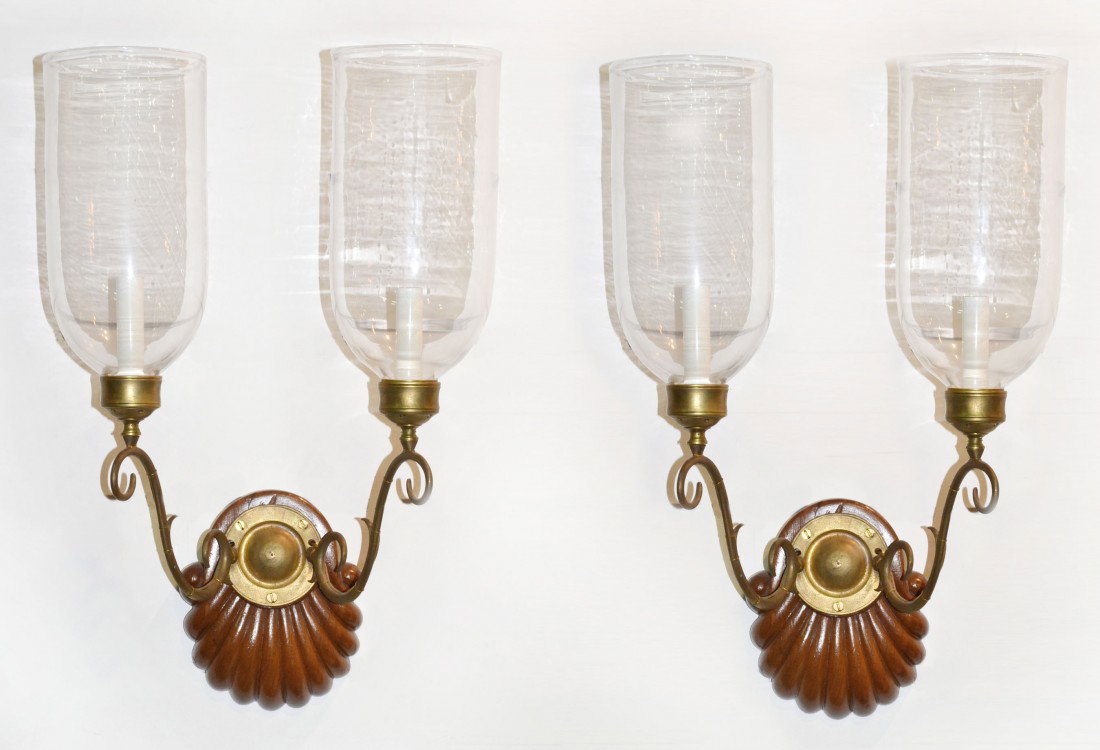 Pair of Wood Carved Two Light Sconces: With shell motif backplate, brass arms and hurricane shades. Height 15 inches.