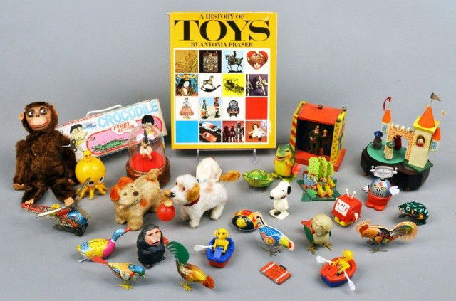 Group of Windup Toys and Music Boxes: Both vintage and reproduction, plastic, wood, and tin, together with a book A History of Toys by Antonia Fraser. Various sizes.